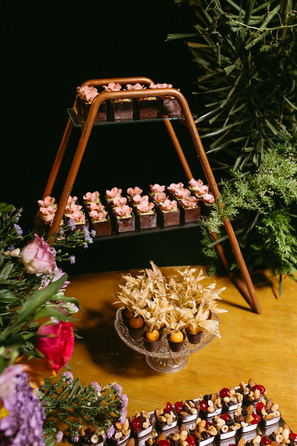 Artisanal chocolates and candies arranged on a wooden table.